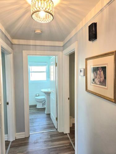 a bathroom with a toilet and a chandelier at 513Company - Sanctuary in Cincinnati