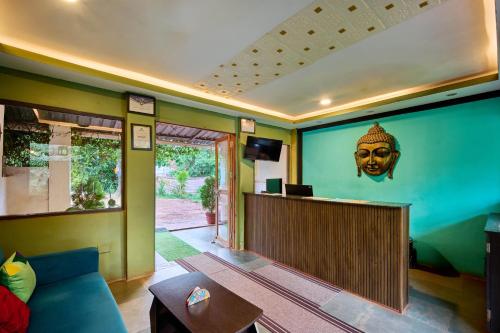 a living room with a partition with a head on the wall at Treebo Lands End Beach Resort - 100m From Morjim Beach in Morjim