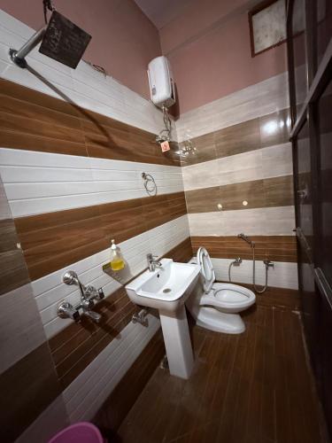 a bathroom with a toilet and a sink at Hotel New Vedas Villa 15 mints From Ram Temple in Ayodhya
