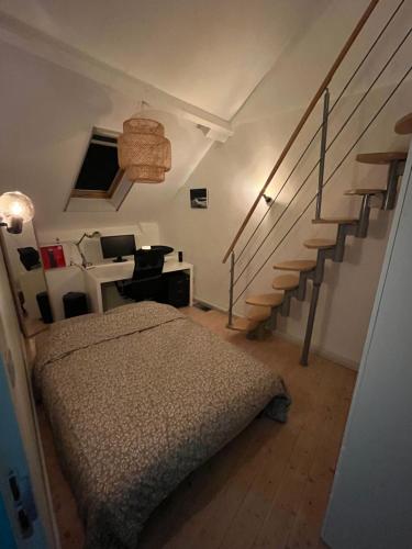a bedroom with a bed and a staircase at Tomorrowland Boom in Boom