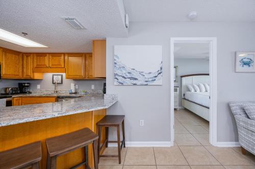 a kitchen and living room with a bed at Phoenix VII 7709 condo in Orange Beach