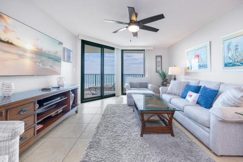 a living room with a couch and a tv at Phoenix VII 7709 condo in Orange Beach
