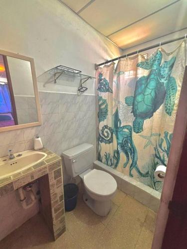 a bathroom with a toilet and a shower curtain at Beachside Cabana with Pool & Beach Access in Nueva Gorgona