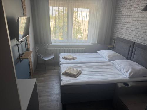 a bed with two pillows on it in a bedroom at Guest Apartments Orłowo in Gdynia