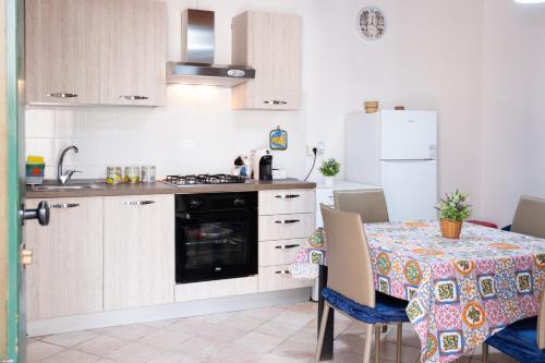 a kitchen with a table with a table cloth on it at A un Passo dal Centro in Modica