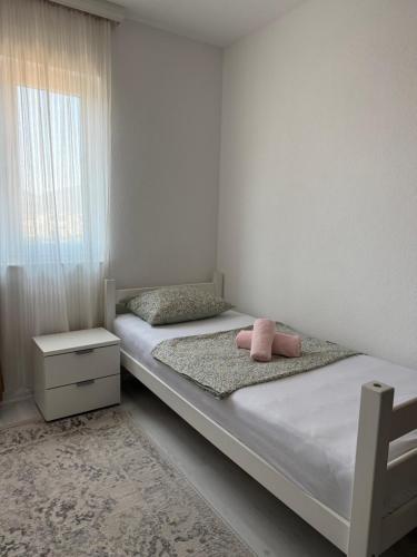 a bedroom with two beds and a window at Apartment Lunette in Mostar