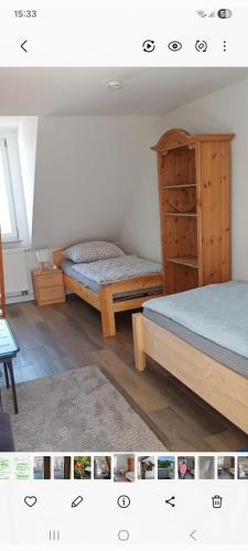 a bedroom with two beds and a dresser at Ferienwohnung Kirschbaumblick in Ettringen