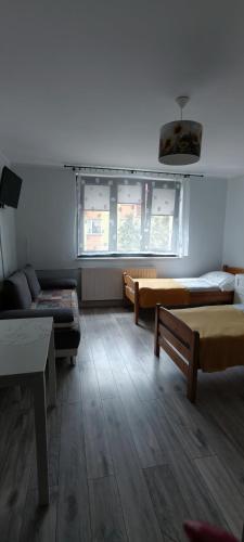 a living room with two couches and a couch at Pokoje gościnne Małgorzata Dąbrowska in Kołobrzeg