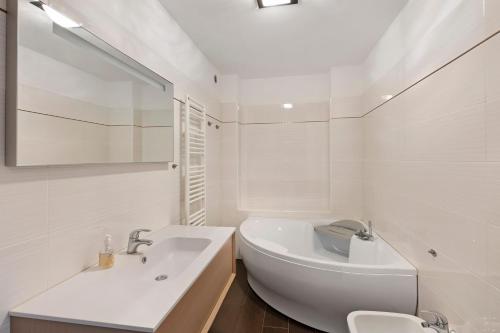 a white bathroom with a sink and a toilet at Villa Capo Berta View in Diano Marina