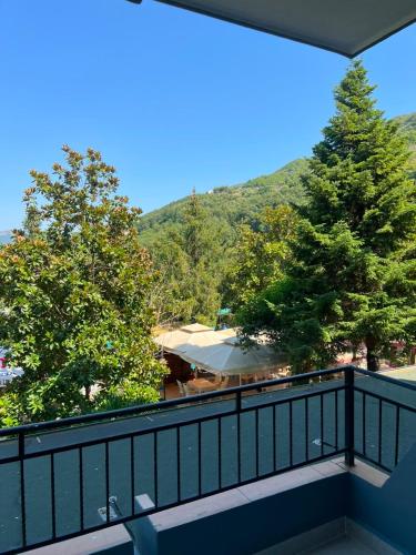 a balcony with a view of trees and a mountain at Hotel Restorant Riza in Tirana