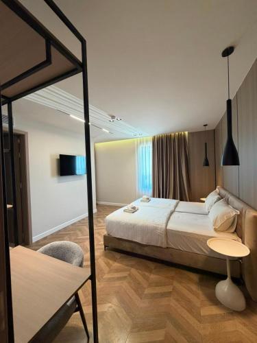 a bedroom with a bed and a table and a chair at Hotel Roden in Golem