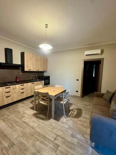 a kitchen and dining room with a table and a couch at ERMAN HOUSE - Dimora del Doge in Dolo