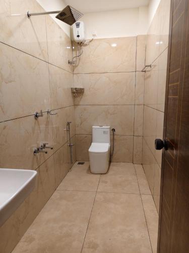 a bathroom with a toilet and a sink at Kerala dormitory edapally in Cochin