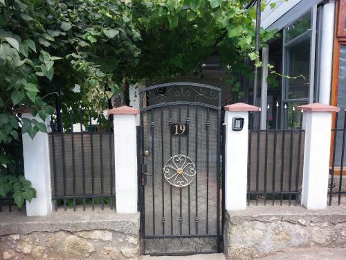 a black door with the number on it in front of a fence at Casa Razvan Vama Veche in Vama Veche