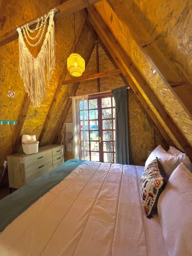 a bedroom with a large bed in an attic at Ioannina Camping- Glamping in Néon Bizánion