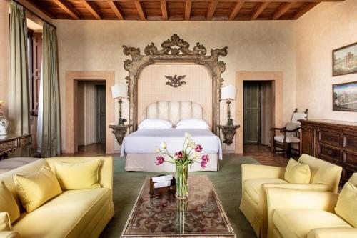 a bedroom with a bed and a table with flowers at La Posta Vecchia Hotel in Ladispoli