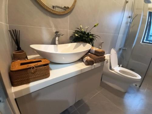a bathroom with a white sink and a toilet at LaiKa in Phú Quốc