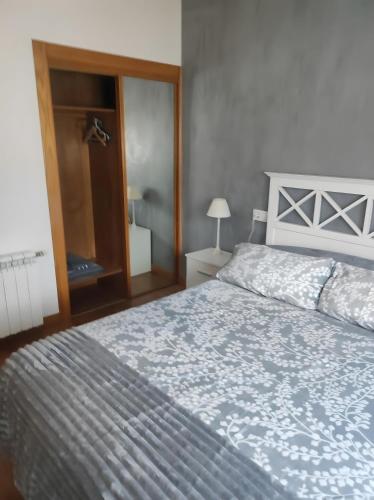 a bedroom with a large bed with a blue blanket at Romanorum in Fermoselle