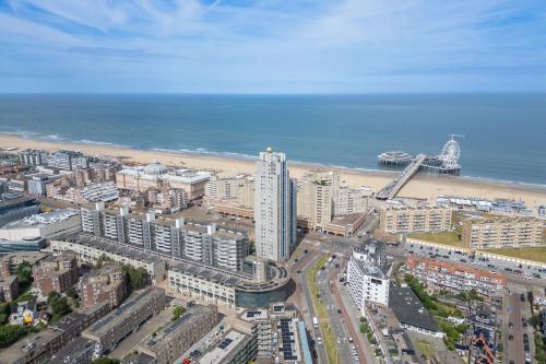 an aerial view of a city with a beach and buildings at Ramada The Hague Scheveningen in Scheveningen