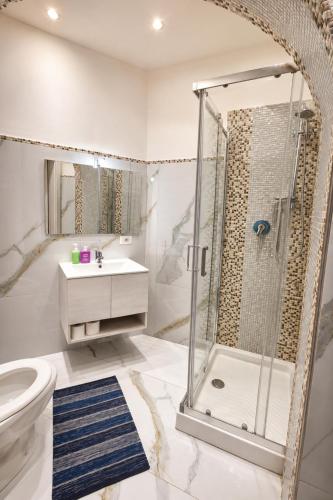 a bathroom with a shower and a toilet and a sink at Riviera AlbaChiara B&b in Anzio