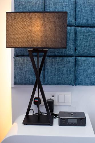 a black lamp sitting on top of a table at M Roof Hotel & Residences in Ipoh
