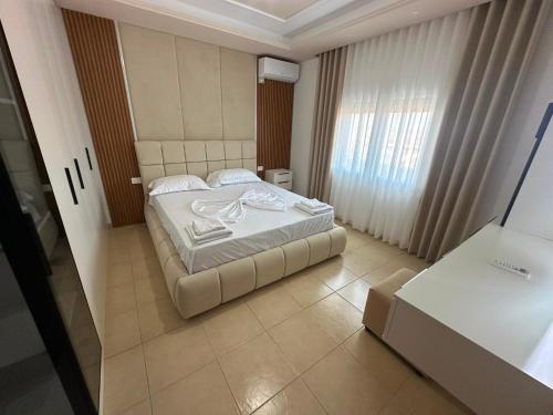 a small bedroom with a bed and a window at Villa Preka in Durrës