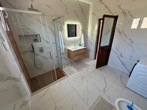 a bathroom with a shower and a sink at Villa Preka in Durrës