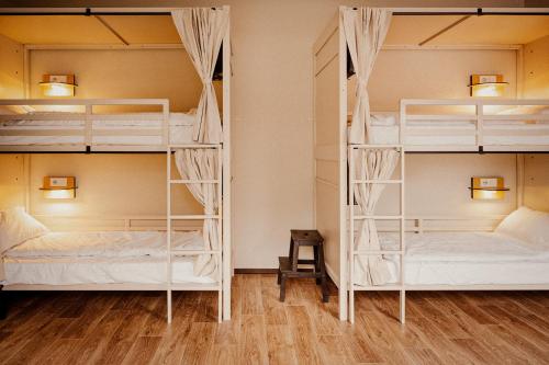 two bunk beds in a room with wood floors at Wombat's City Hostel Vienna Naschmarkt in Vienna