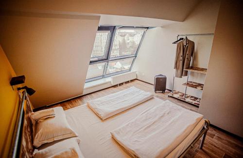 a large room with two beds and a window at Wombat's City Hostel Vienna Naschmarkt in Vienna