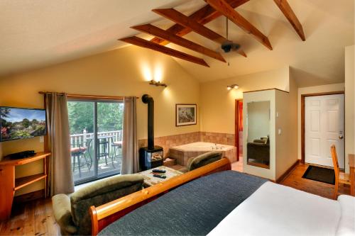 a bedroom with a bed and a living room at The Breadalbane Inn in Fergus