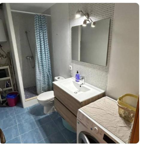 a bathroom with a sink and a toilet and a mirror at Under the Mediterranean sky in Terrassa
