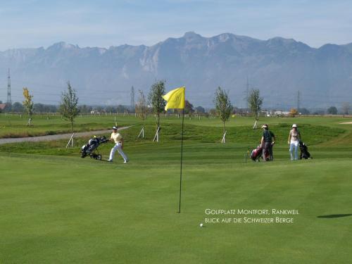 a group of people playing golf on a golf course at Hotel Restaurant Rössle in Rankweil