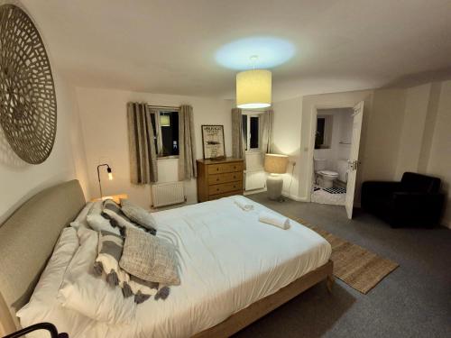 a bedroom with a bed and a living room at Beach Break Aberavon Holiday Home by the Sea in Port Talbot