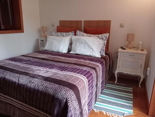 a bedroom with a large bed with white pillows at VianasHome in Amarante