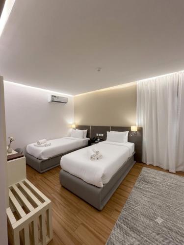 a hotel room with two beds and a rug at Grand Museum Pyramids in Cairo