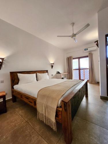 a bedroom with a large bed in a room at Maji Pearl Hotel & Spa in Nungwi