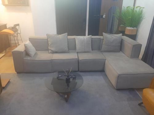 a living room with a couch and a glass table at Jasper luxury homes in Abuja