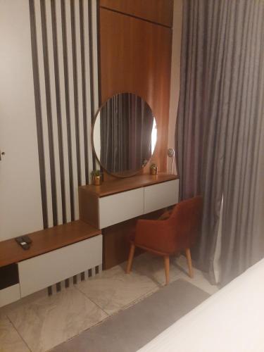 a dressing table with a mirror and a chair in a room at Jasper luxury homes in Abuja