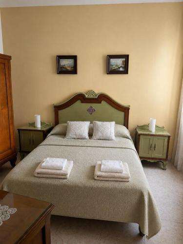 a bedroom with a bed with two towels on it at Eco Mar - Cedeira in Cedeira