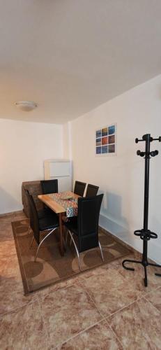 a living room with a table and chairs and a camera at Medin BD in Budva