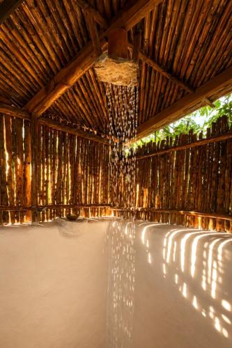 a stage with a wooden ceiling with a chandelier at Aldea Ancestral by ID Hotel in Barbosa