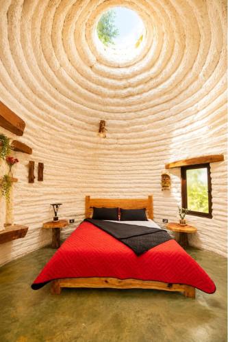 a bedroom with a large bed with a wooden ceiling at Aldea Ancestral by ID Hotel in Barbosa