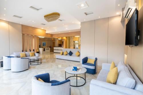 a lobby with couches and tables and a television at AlQasr - Almansak in Abha