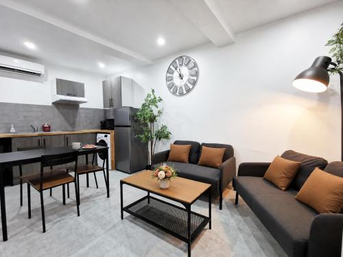 a living room with a couch and a table at Le temps d'une pause -4- in Cepoy