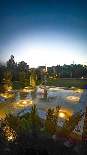 a lit up fountain in a park at night at Hamzas production in Islamabad