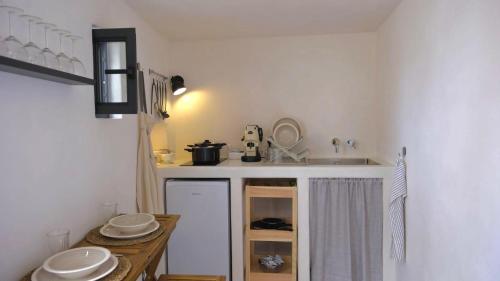 a kitchen with a sink and a counter with plates at Casa Fidelia in Ceglie Messapica