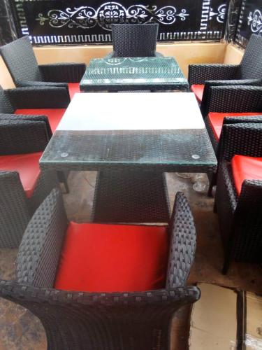 a table and chairs with red and white at Villa Liga Hotels Concerpts in Erunmu