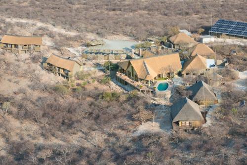 an aerial view of a house with a swimming pool and a yard at Safarihoek Lodge in Kamanjab
