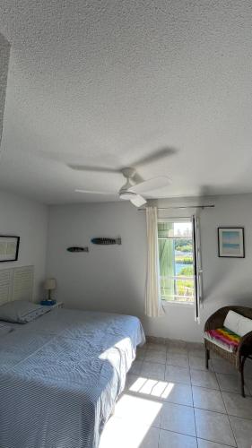 a bedroom with a bed and a ceiling fan at La Paloma in Aigues-Mortes