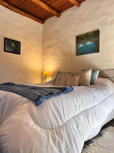 a bedroom with a large white bed in a room at Pamayu Mar de Cobo in Mar de Cobo